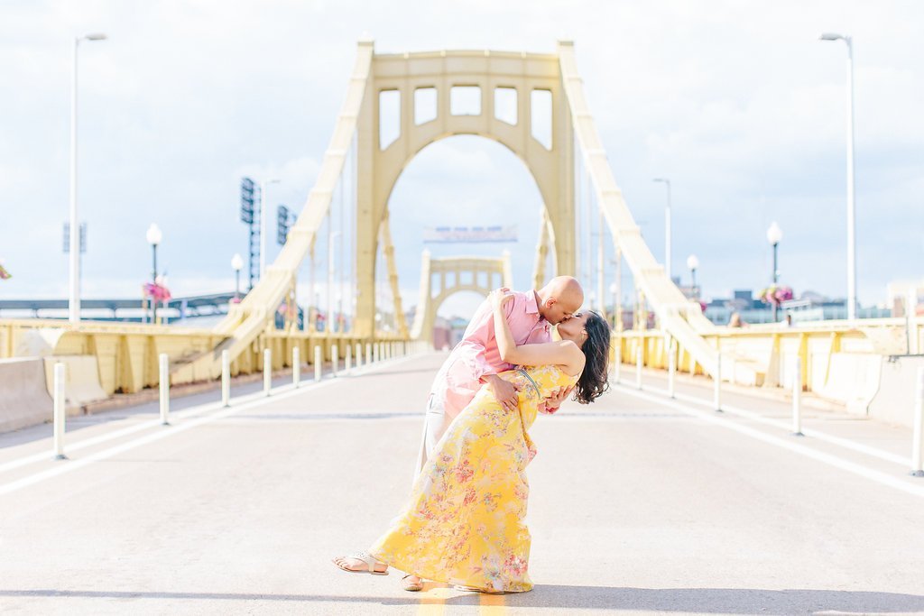 Fine Art Wedding Photography - Lauren Renee Photography groom dipping his bride in the center of the Roberto Clemente Bridge
