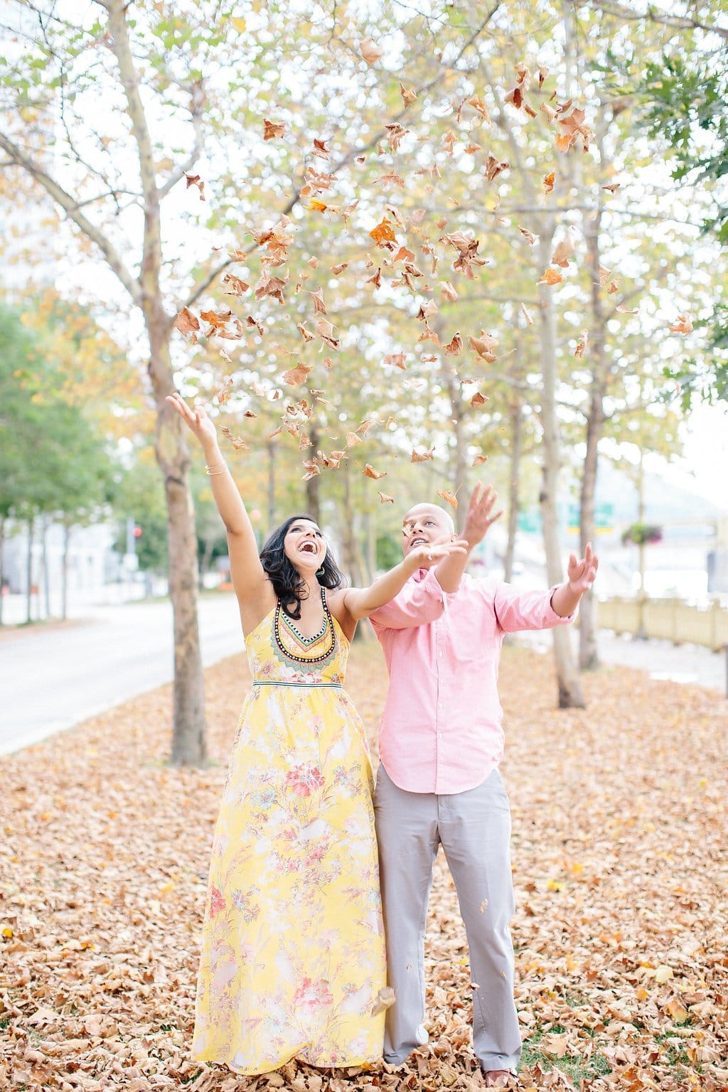 Fine Art Wedding Photography - Lauren Renee Photography Bride and groom dancing and throwing leaves during engagement Session