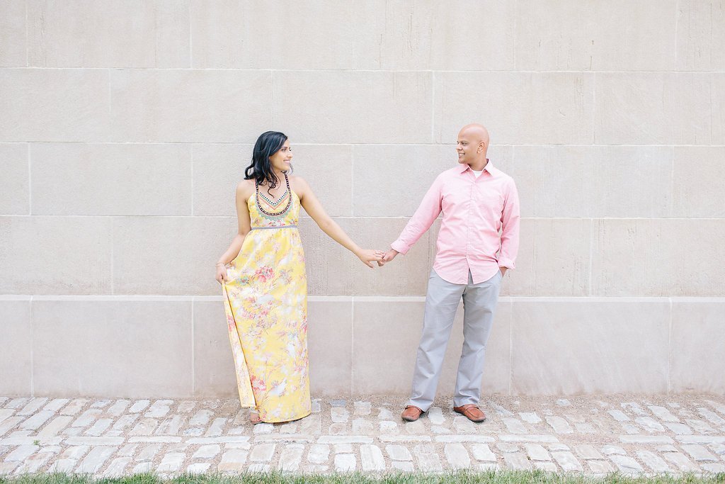 Fine Art Wedding Photography - Lauren Renee Photography couple holding hands for portraits in front of a white stone wall at the point