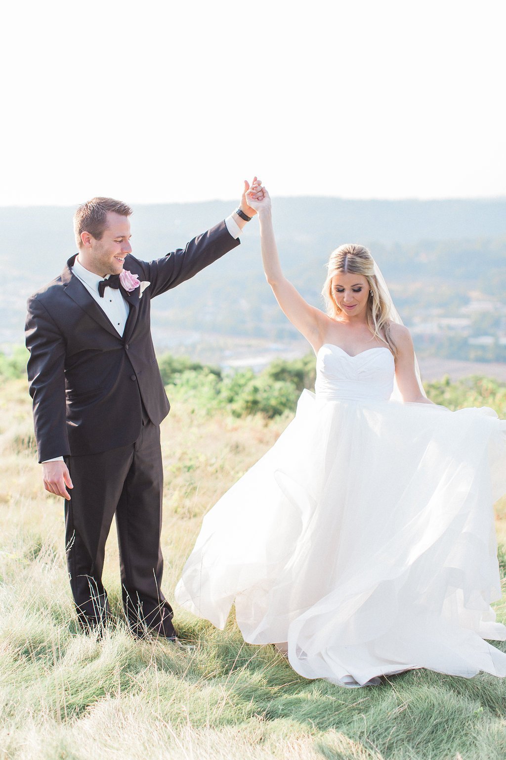 Lauren Renee Photography Bride and groom dancing together in a field