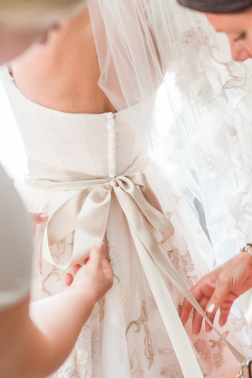 Destination Wedding Photography, Lauren Renee Photography Bride getting her dress on with help from her bridesmaids
