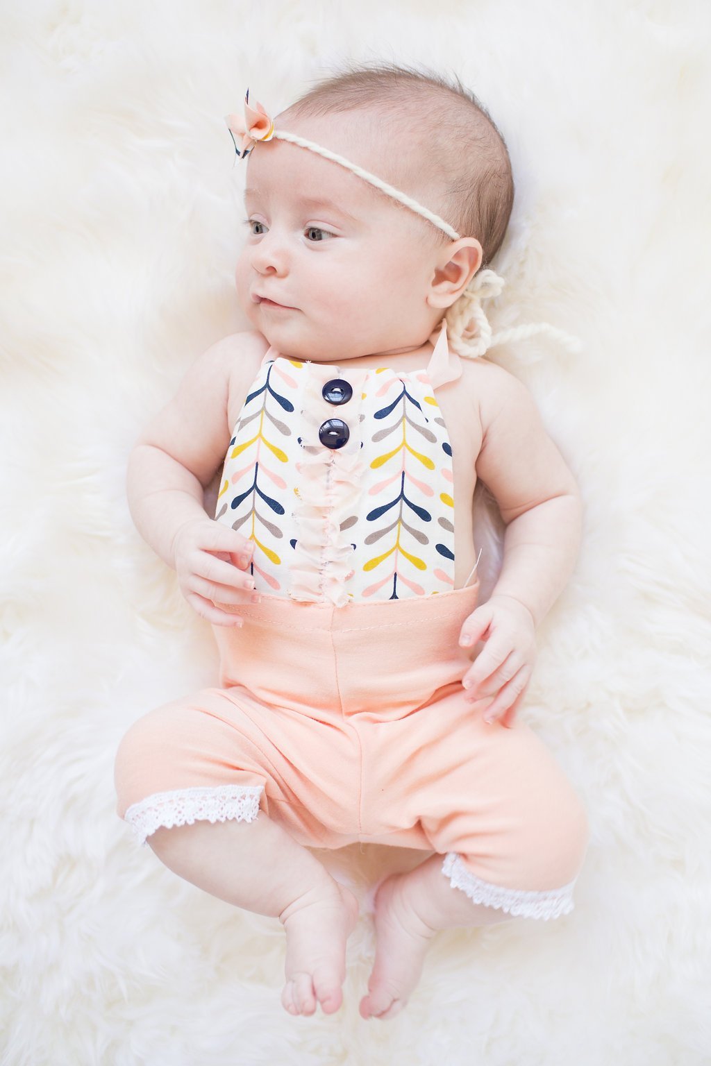 Newborn Photography - Lauren Renee Photography baby laying on white fur rug