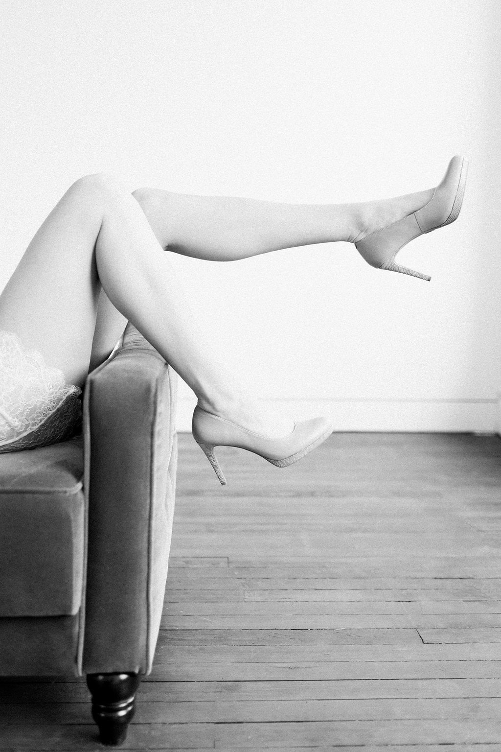 Lauren Renee Photography Black and white photo of brides legs with heels on