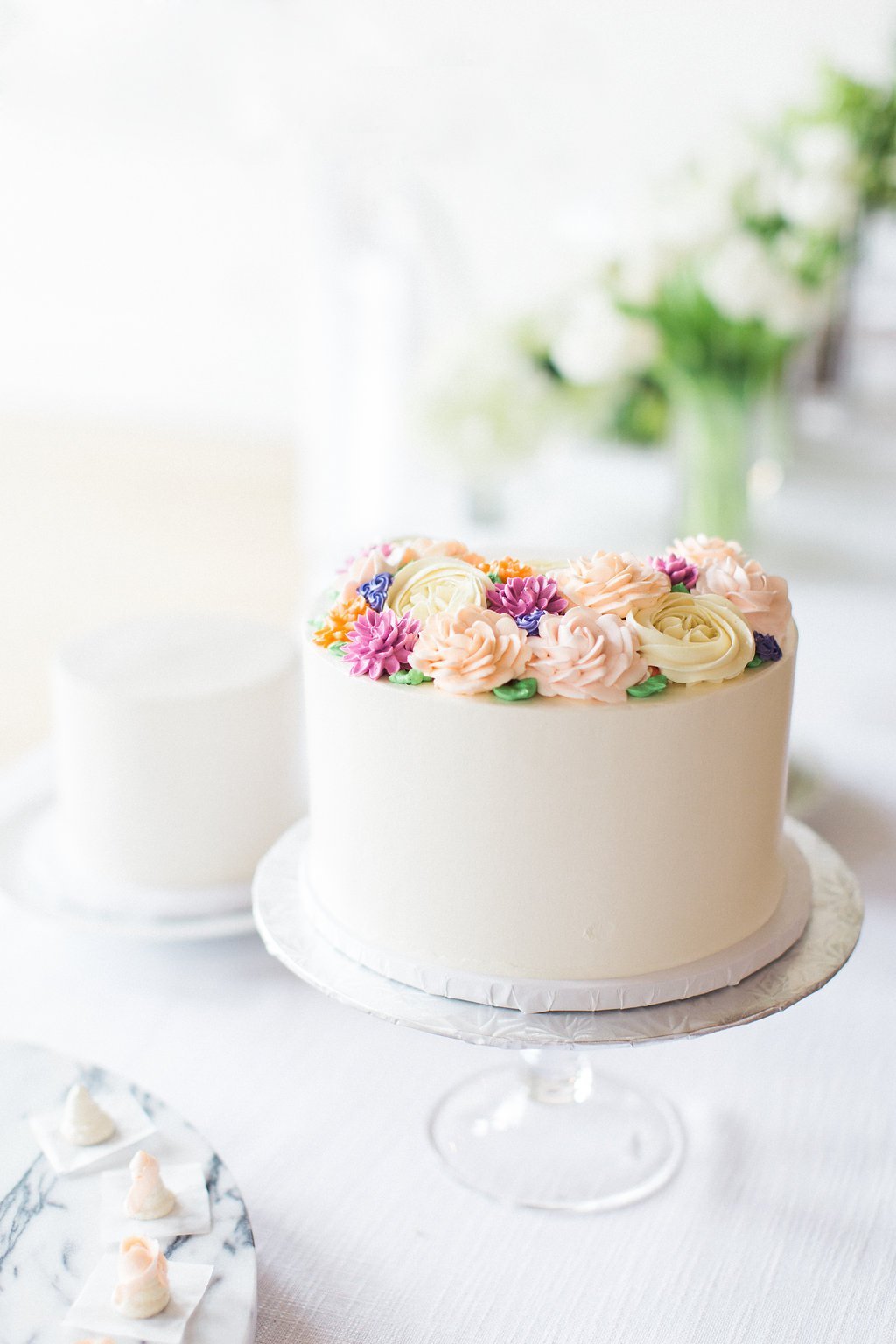 Published on SMP - Lauren Renee Photography white one tiered cake with butter cream frosting flowers