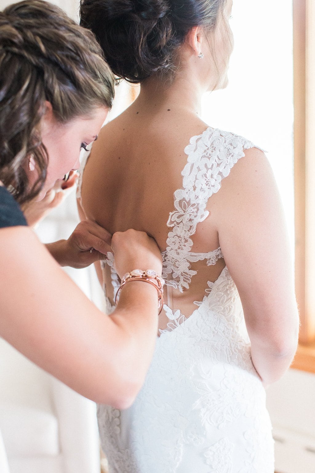 Lauren Renee - Pittsburgh Fine Art Wedding Photography Bride's sister helping her into her wedding dress