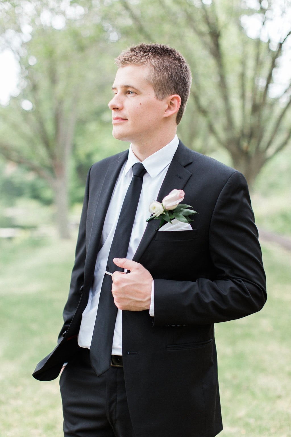 Lauren Renee - Pittsburgh Fine Art Wedding Photography Groom posing in his black tux while holding his lapel