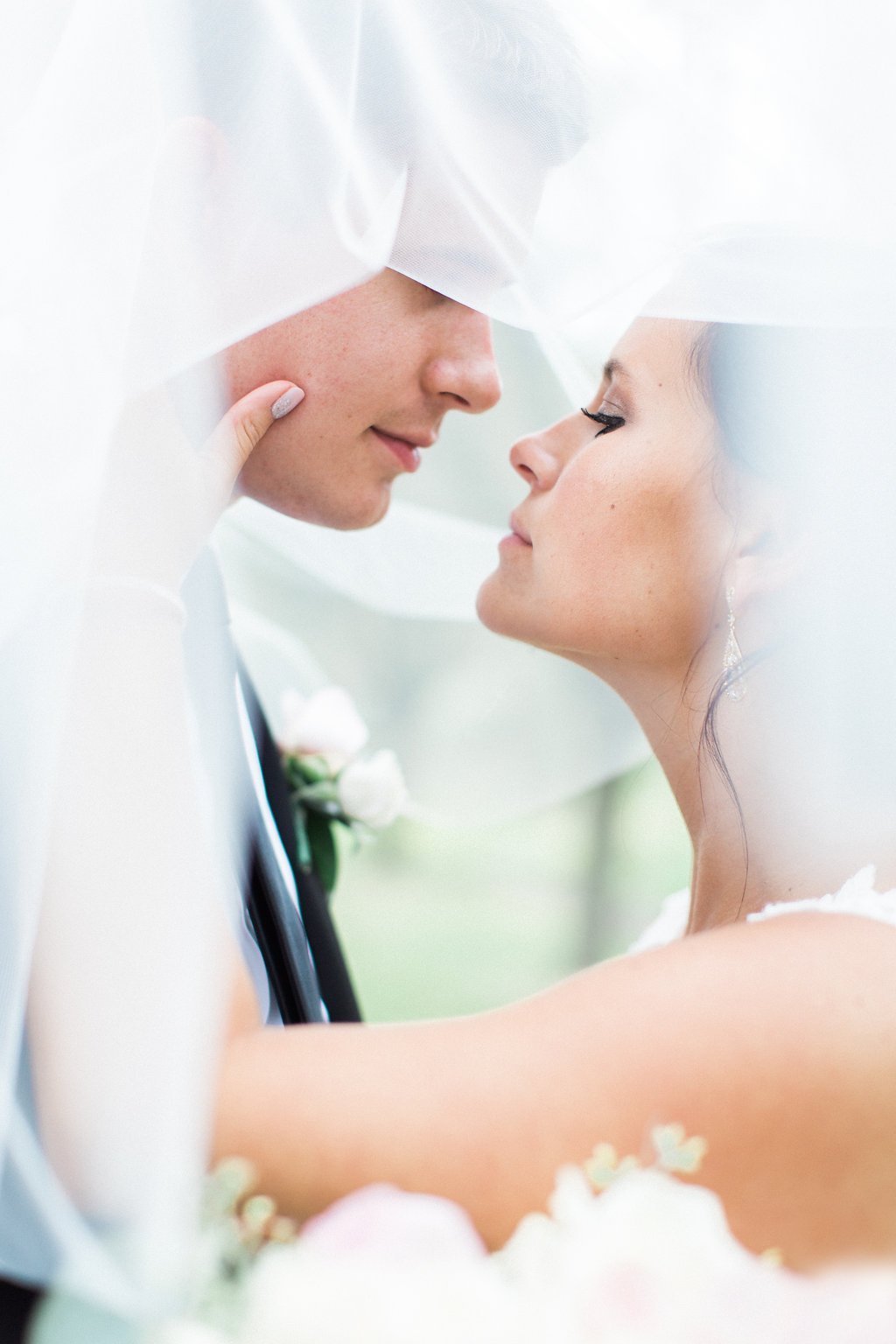 Lauren Renee - Pittsburgh Fine Art Wedding Photography Close up photo of bride and groom about to kiss under veil