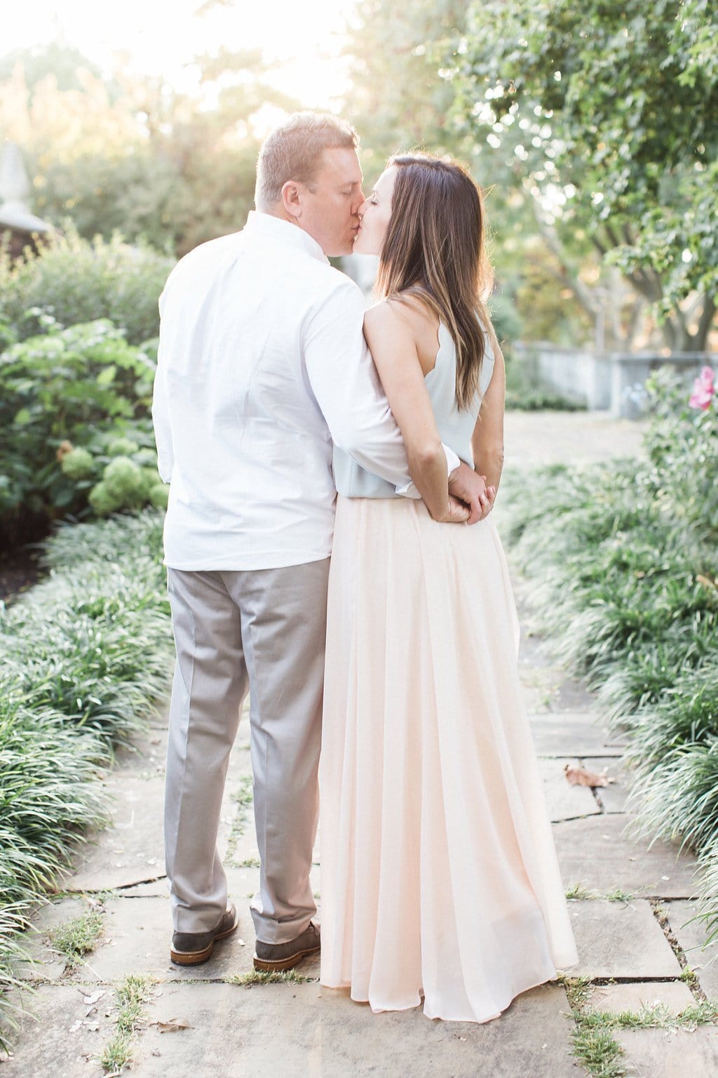 Lauren Renee - Pittsburgh Wedding Photography Couple kissing wearing clothing in a pastel color palette