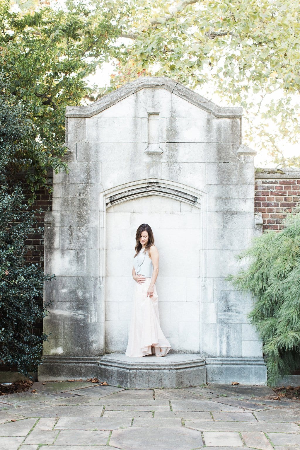 Lauren Renee - Pittsburgh Wedding Photography Woman standing in the center of a stone wall with arch