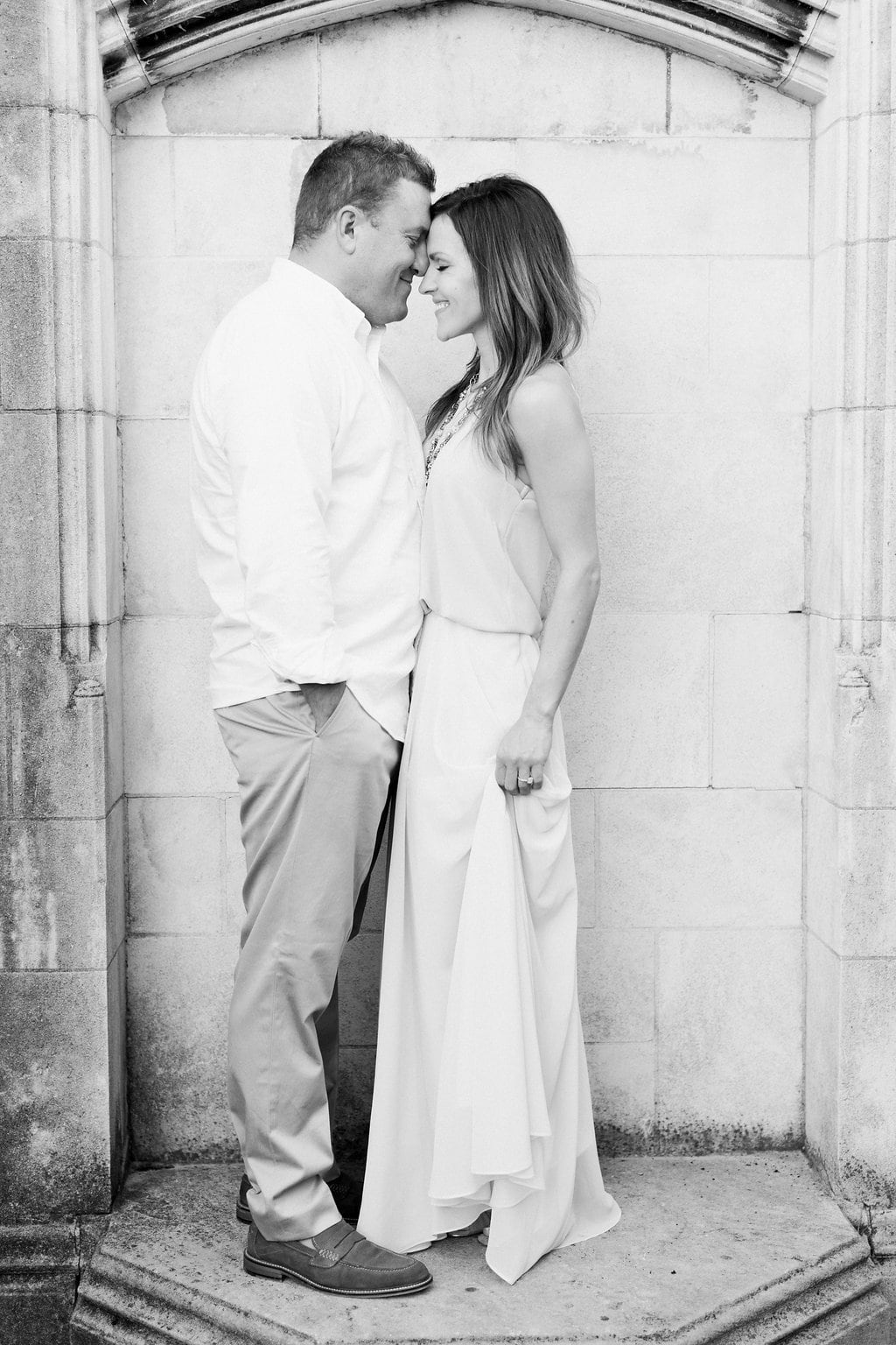 Lauren Renee - Pittsburgh Wedding Photography Black and white photo of couple touching foreheads while standing in front of stone wall