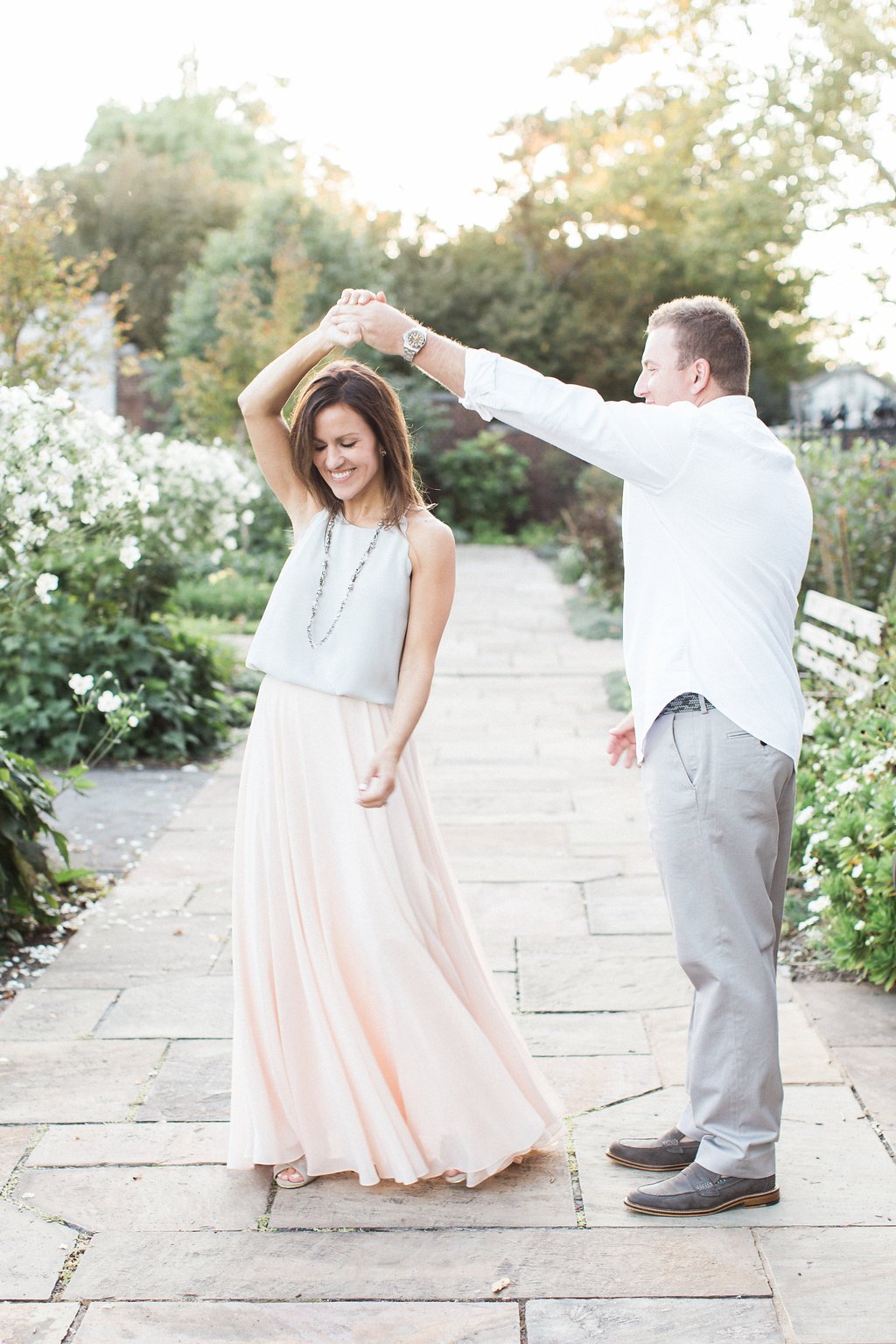 Lauren Renee - Pittsburgh Wedding Photography Man spinning woman while dancing in the middle of a Pittsburgh park