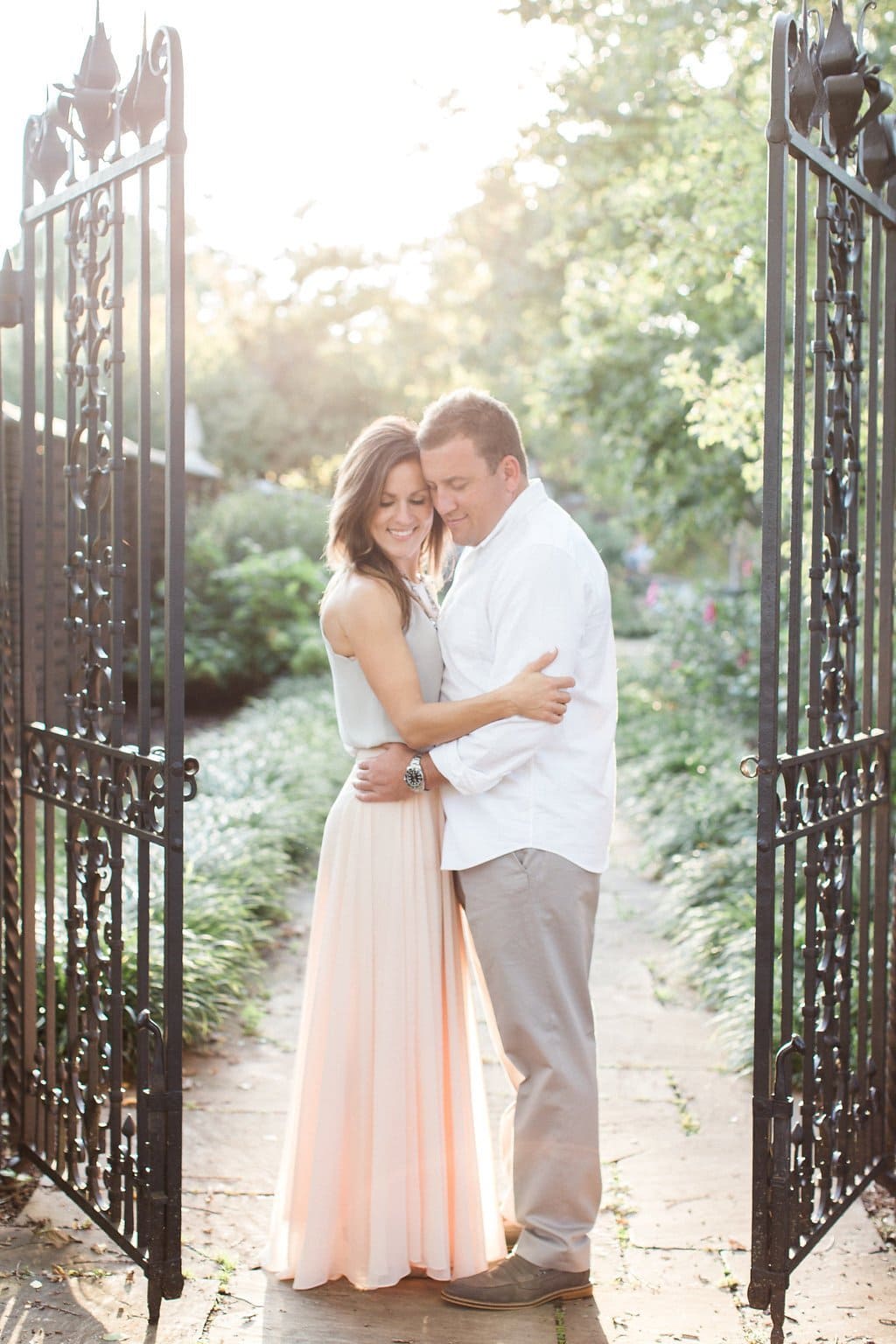 Lauren Renee - Pittsburgh Wedding Photography Bride and groom standing together embracing in between wrought iron gates