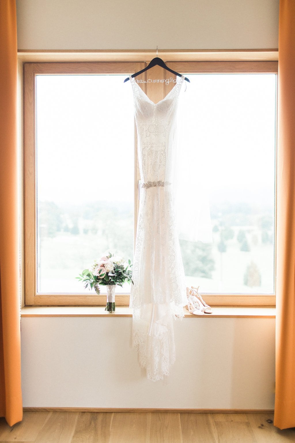 Golf Club Wedding - Lauren Renee Photography Wedding dress hanging in window with shoes and bouquet
