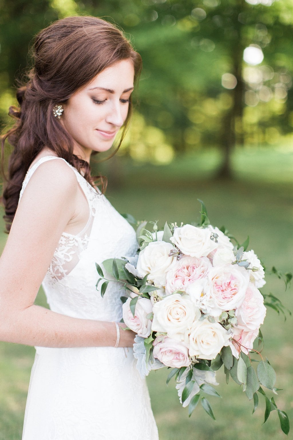 Golf Club Wedding - Lauren Renee Photography Portrait of brie holding bouquet and looking down at the flowers