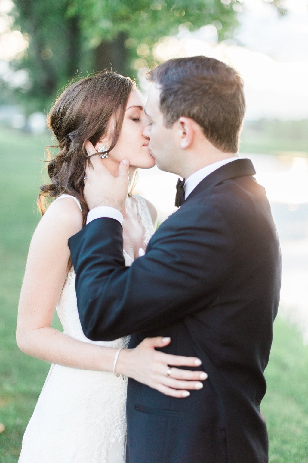 Golf Club Wedding - Lauren Renee Photography Bride and groom kissing during sunset on golf course
