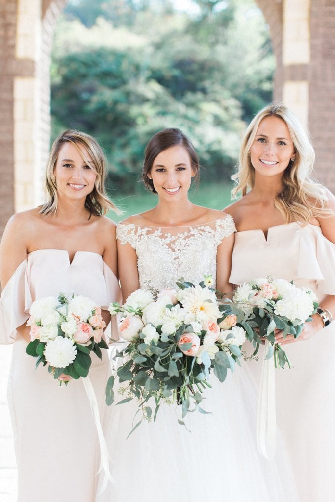 Bride with her bridesmaids outside of the church