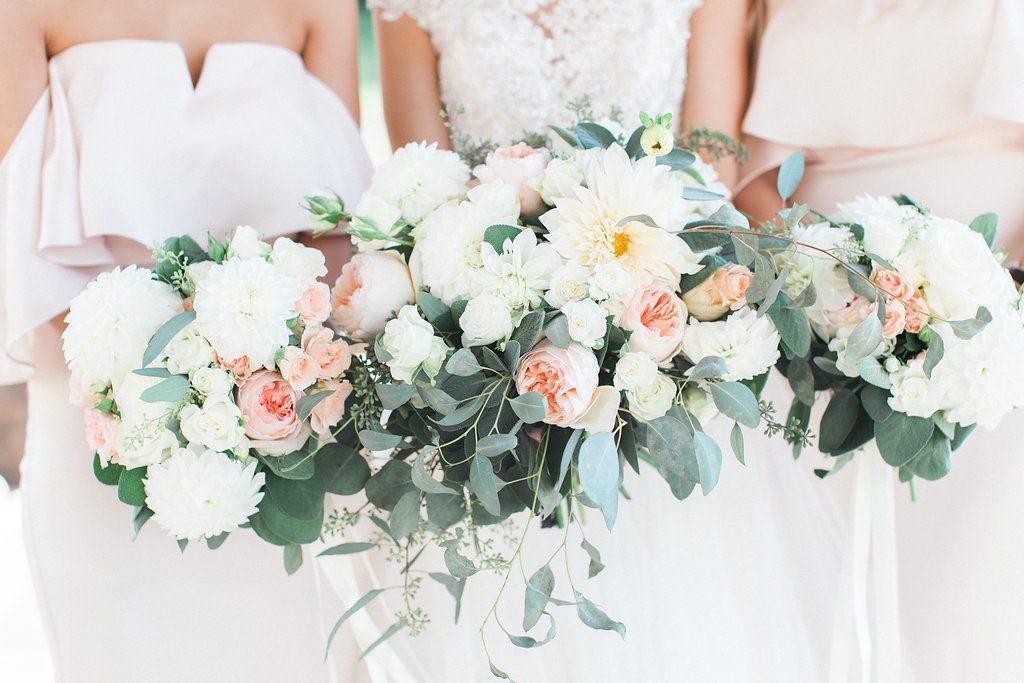 Photograph of bride and bridesmaids bouquets blush pink green and white