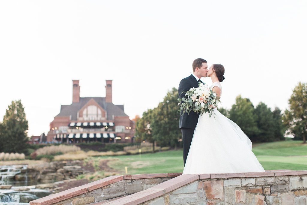 Sunset portraits of the bride and groom on the bridge at the Club at Nevillewood