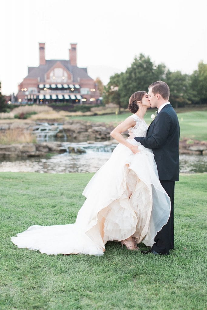 Bride and Groom on the golf course at Nevillewood sharing a kiss at sunset