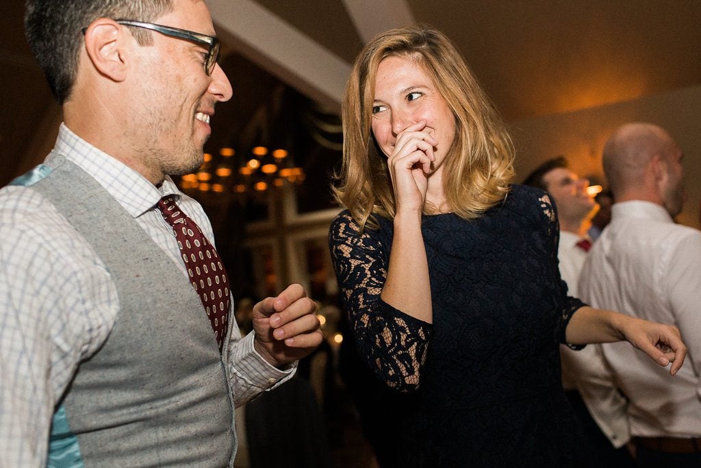 Guests celebrating and dancing at the wedding reception