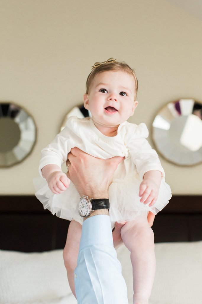 Dad holding baby in the air during family photography session