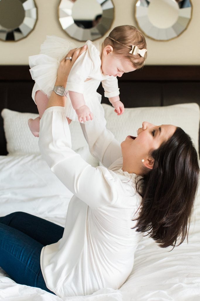 Mom holding baby up in the air during family photography session at their Pittsburgh home