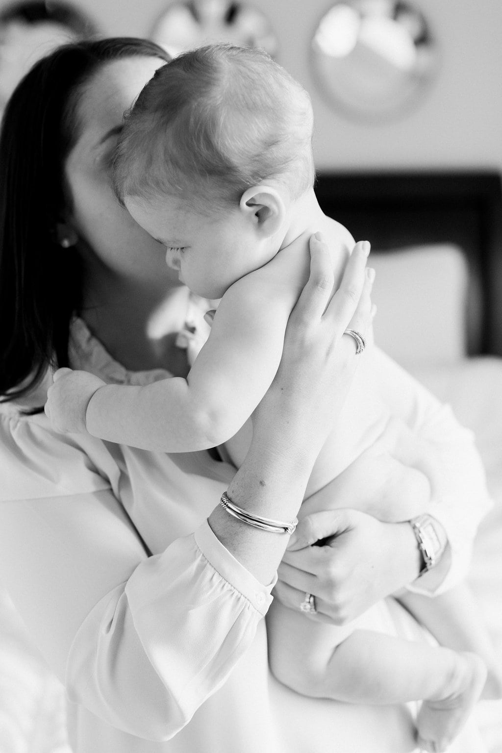 Lifestyle Photography - Lauren Renee Photography Mom kissing baby on the cheek in a black and white photograph