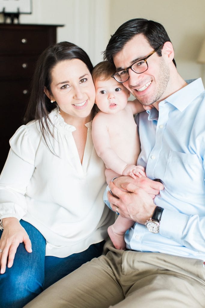 Parent's holding baby during a in home family photography session