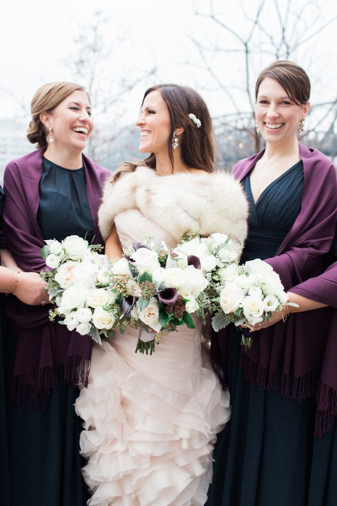 Bride with her bridesmaids on a snowy and cold winter day in the Southside of Pittsburgh