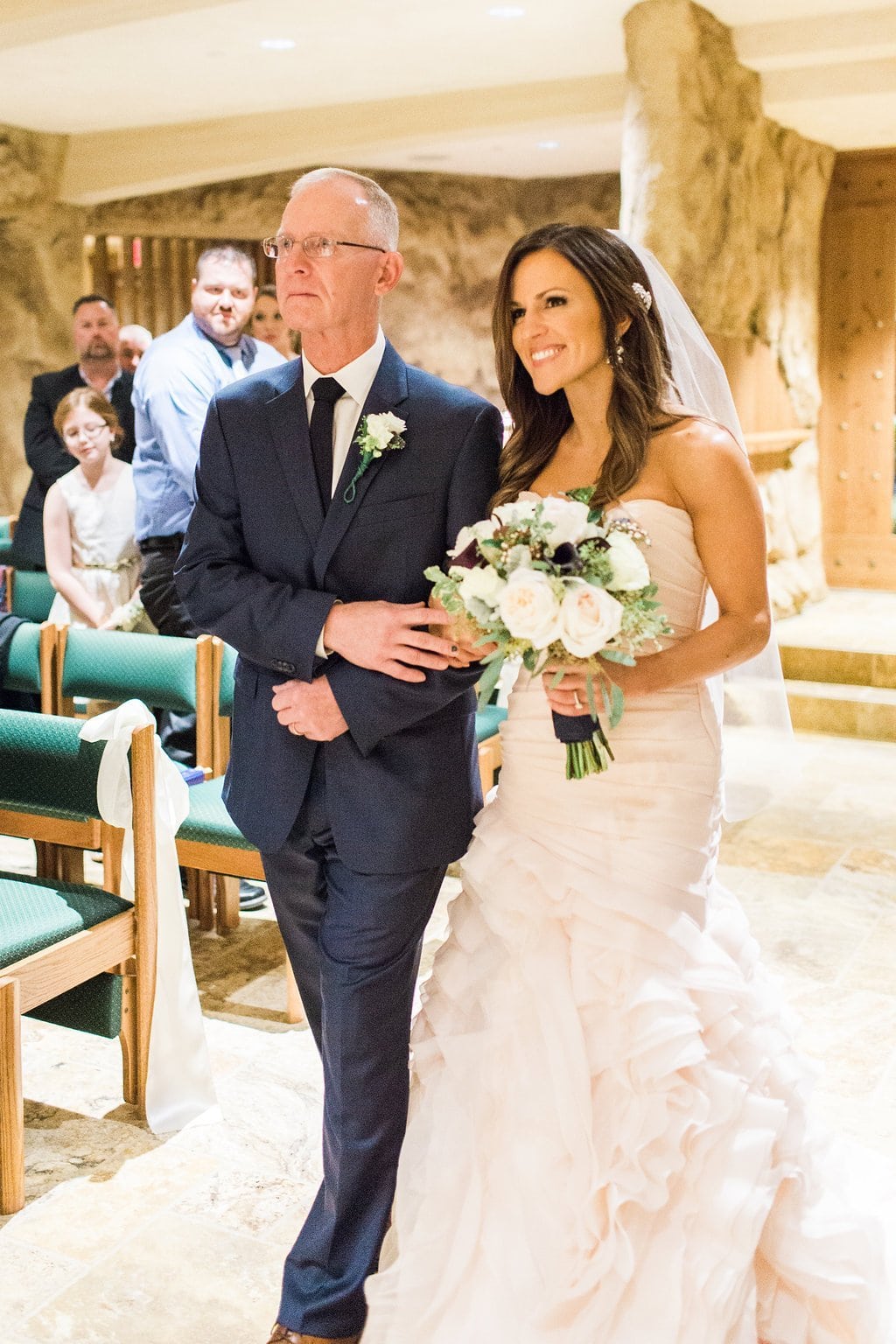 Pittsburgh Wedding Photography - Lauren Renee Photography The bride being walked down the aisle by her father in the grotto of the Saints John and Paul Roman Catholic Church