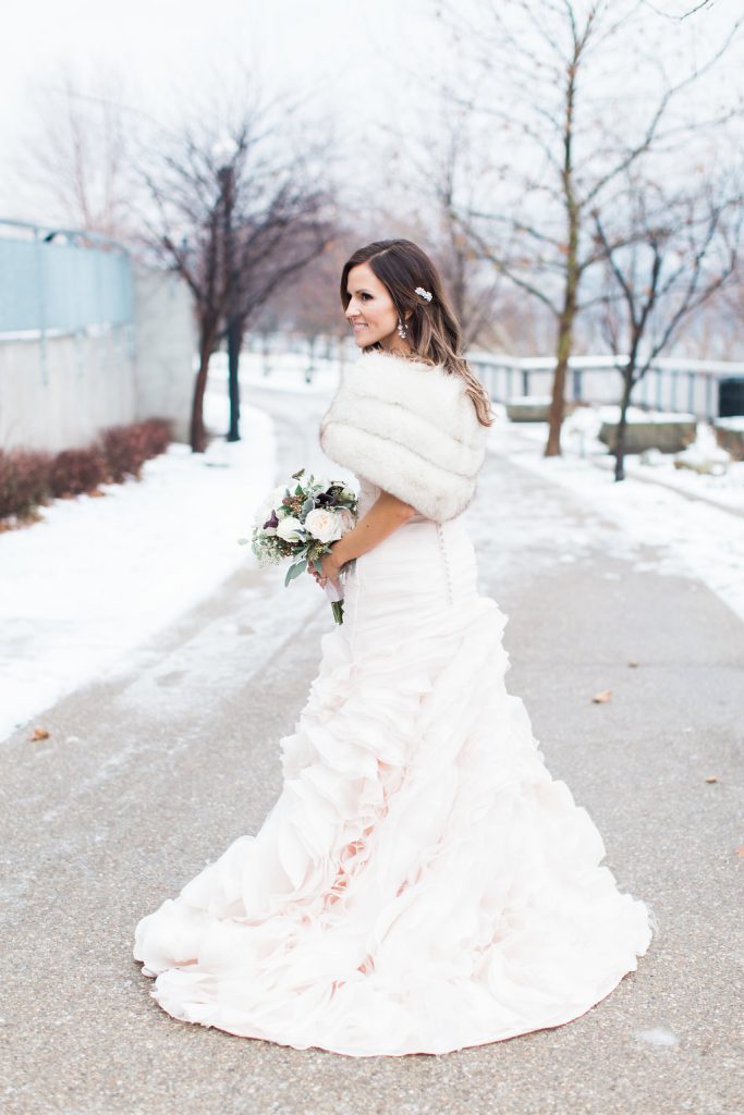 Bride wearing blush pink wedding gown in the snow during winter wedding in Pittsburgh