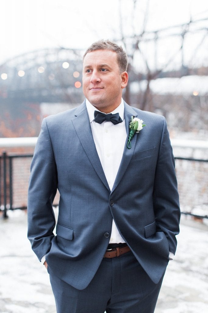 Portrait of the groom outside in the snow during winter wedding at J. Verno Studios