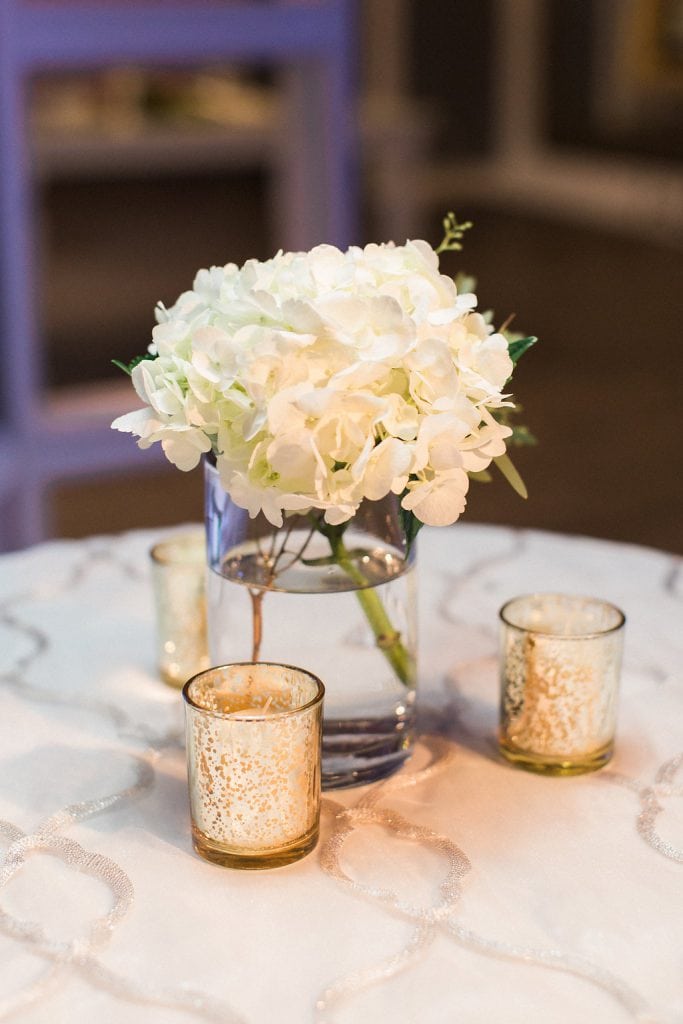 Cocktail details flowers and votive candles during reception at J. Verno Studios