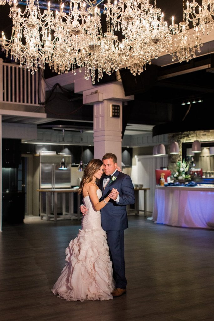 Bride and Groom sharing their first dance under the chandeliers at J. Verno Studios