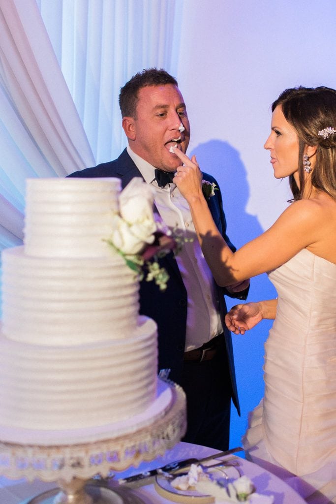 Bride and Groom cutting their wedding cake at their reception