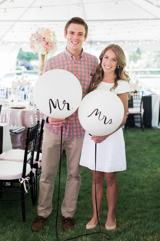 bride and groom with white mr. and mrs. balloons at bridal shower