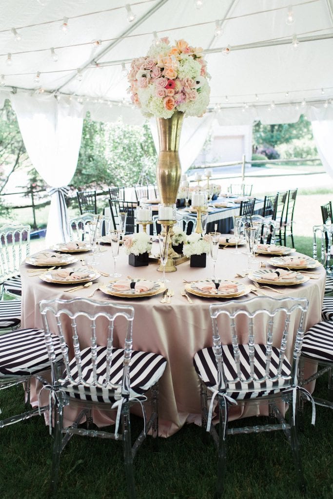 bridal shower with pink table cloth, black and white accents and florals