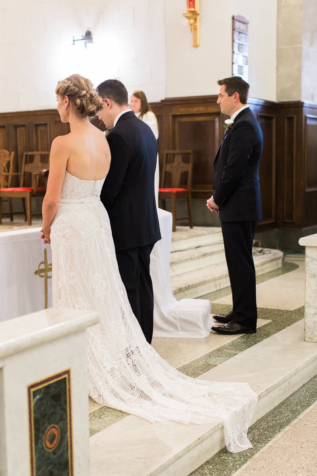 Bride is walked down the aisle by man who received her father's donated heart - Lauren Renee Photography Bride and groom at the alter during their wedding ceremony at St. Anselm Catholic Church