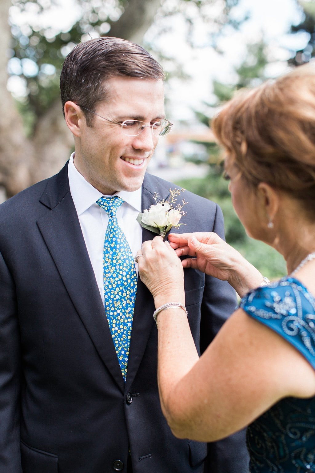 Bride is walked down the aisle by man who received her father's donated heart - Lauren Renee Photography Groom getting boutonnière pinned on by mother at St. Anselm Catholic Church