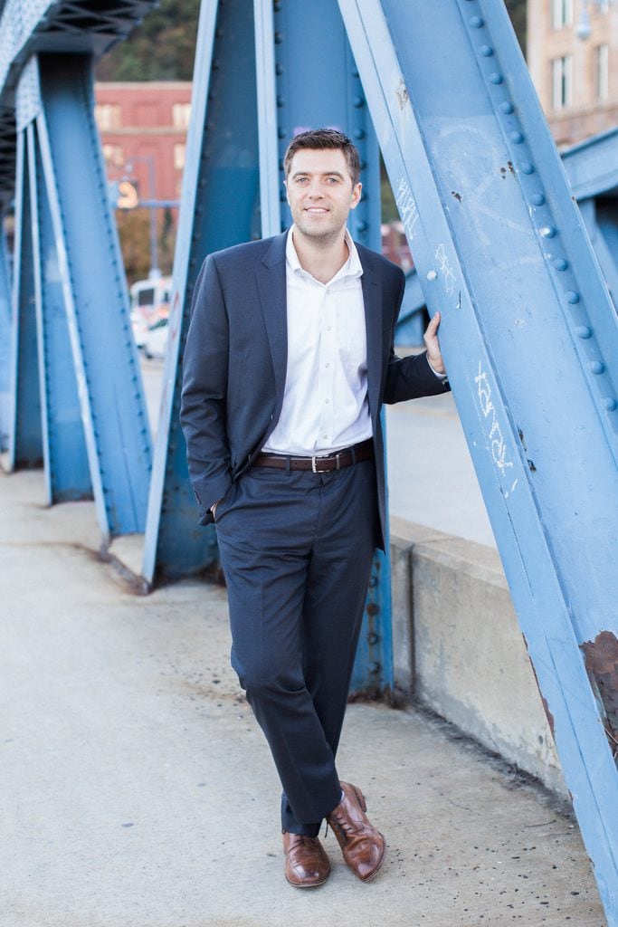 Mount Washington and South Side Engagement Groom on Smithfield Street Bridge during engagement photography session