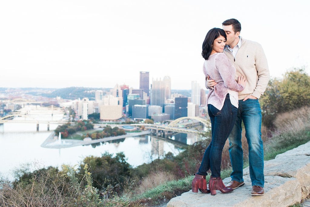 Mount Washington and South Side Engagement Bride and Groom posing with the Pittsburgh city skyline during engagement photos