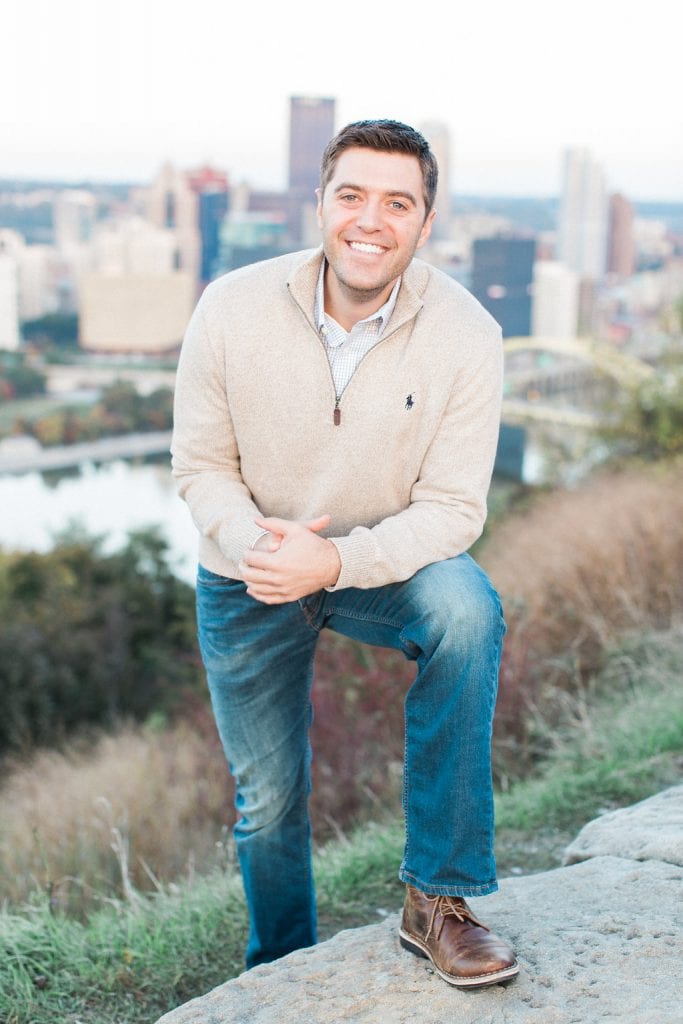 Mount Washington and South Side Engagement Portrait of groom during engagement photos over looking Pittsburgh Downtown City Skyline