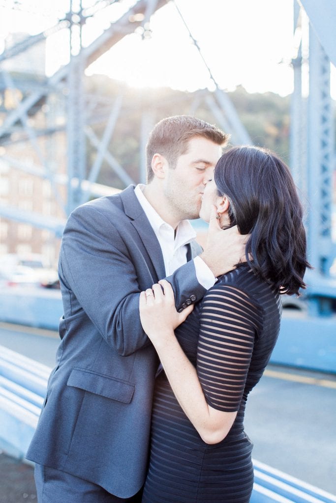 Mount Washington and South Side Engagement Couple kissing on the Smithfield Street Bridge