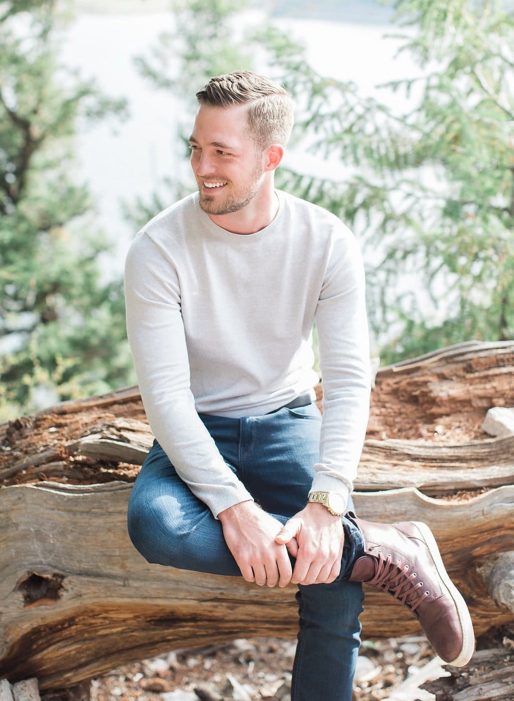 Destination Engagement Session - Lauren Renee Photography groom sitting on a log smiling