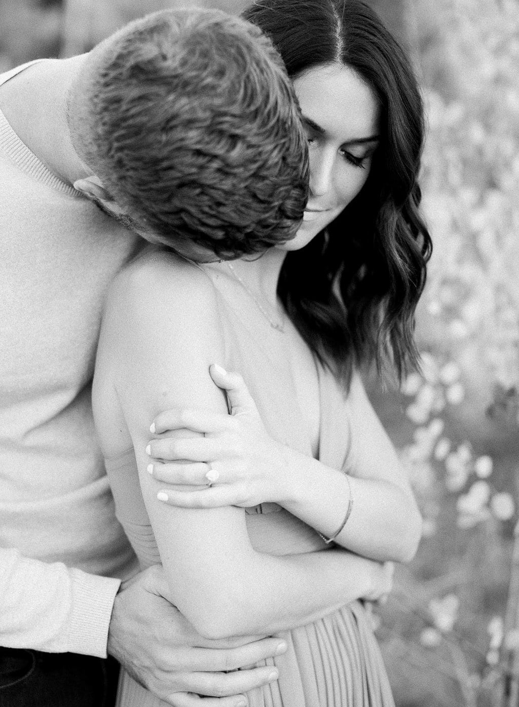 Destination Engagement Session - Lauren Renee Photography Groom kissing bride's neck in black and white