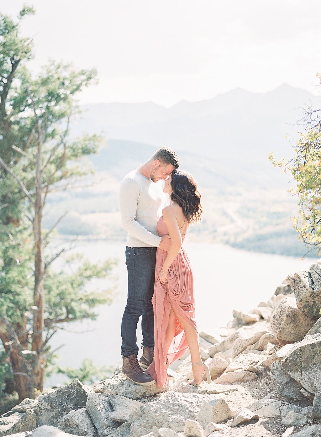 Destination Engagement Session - Lauren Renee Photography Bride and groom standing on mountain top in the sun