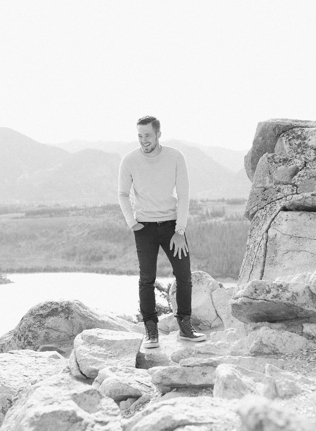 Destination Engagement Session - Lauren Renee Photography Groom laughing on mountain side in black and white