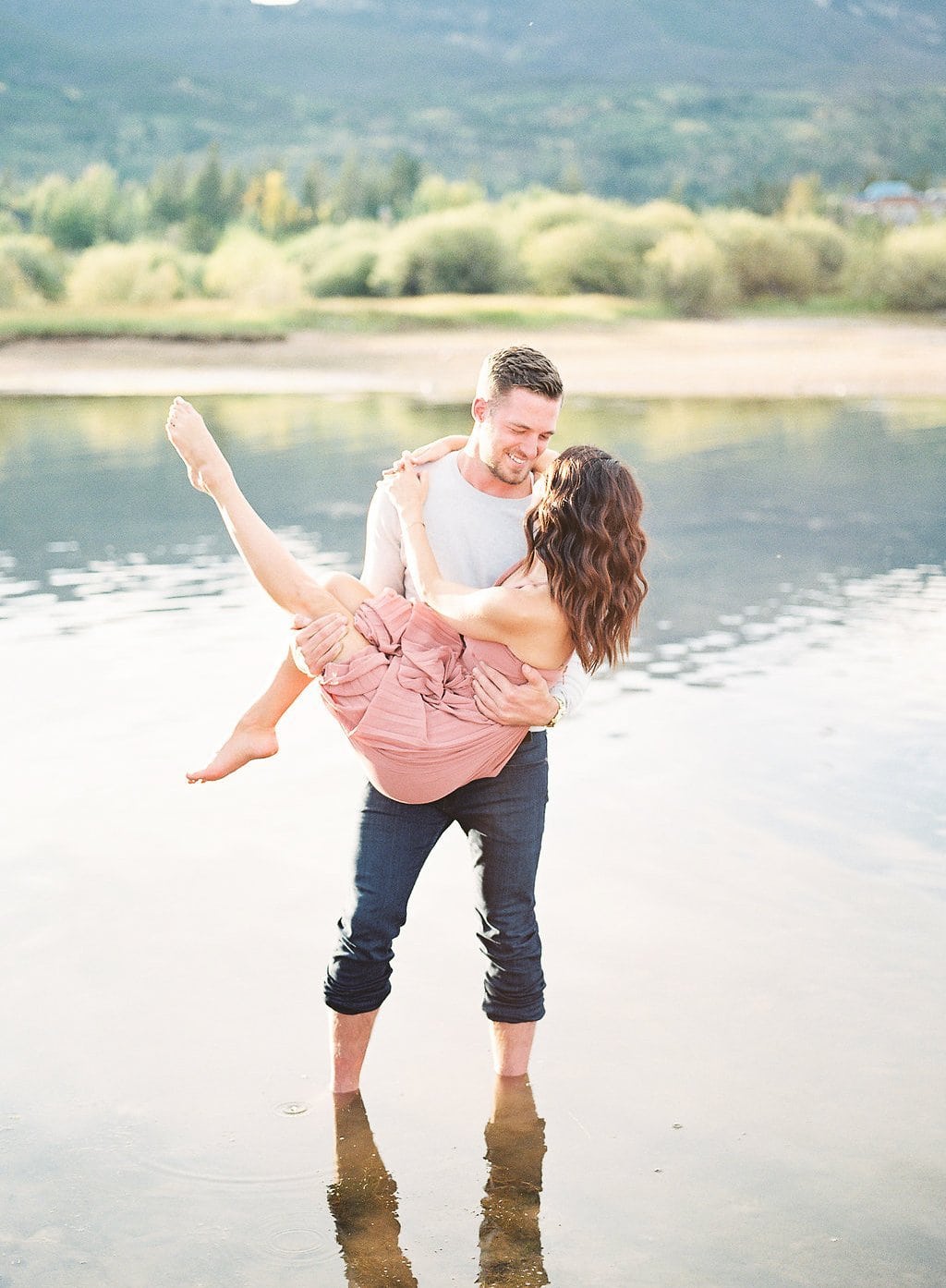 Destination Engagement Session - Lauren Renee Photography Groom holding the bride up while walking in lake water