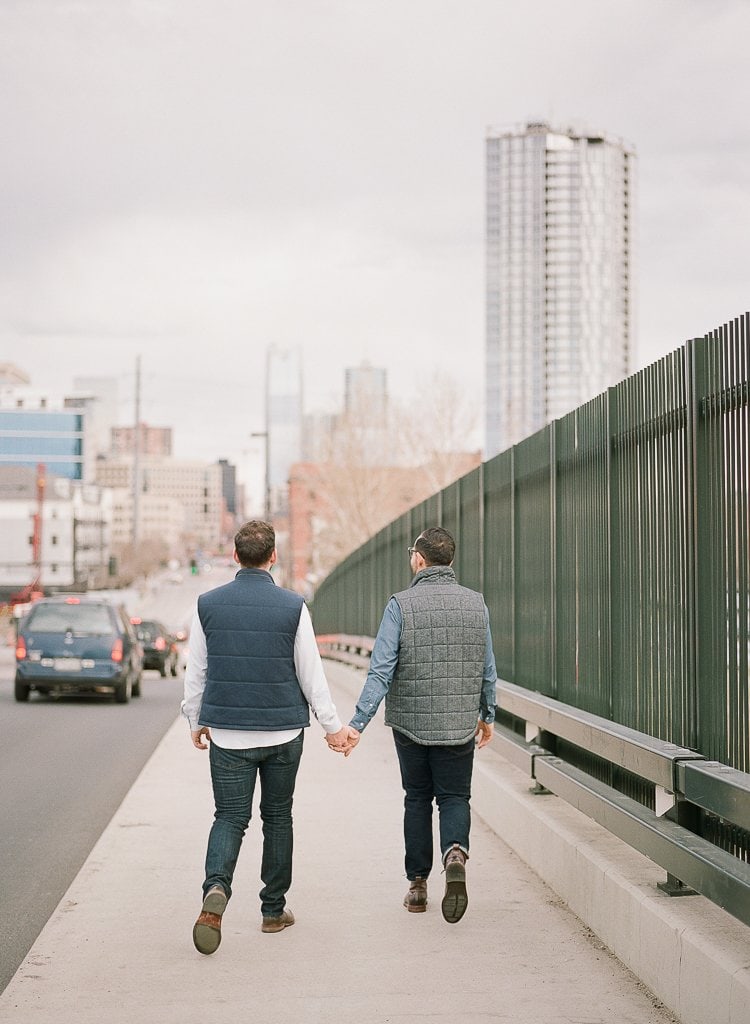 Sam-Sex Engagement Session - Lauren Renee Photography two men holding hands and walking in downtown Denver Colorado