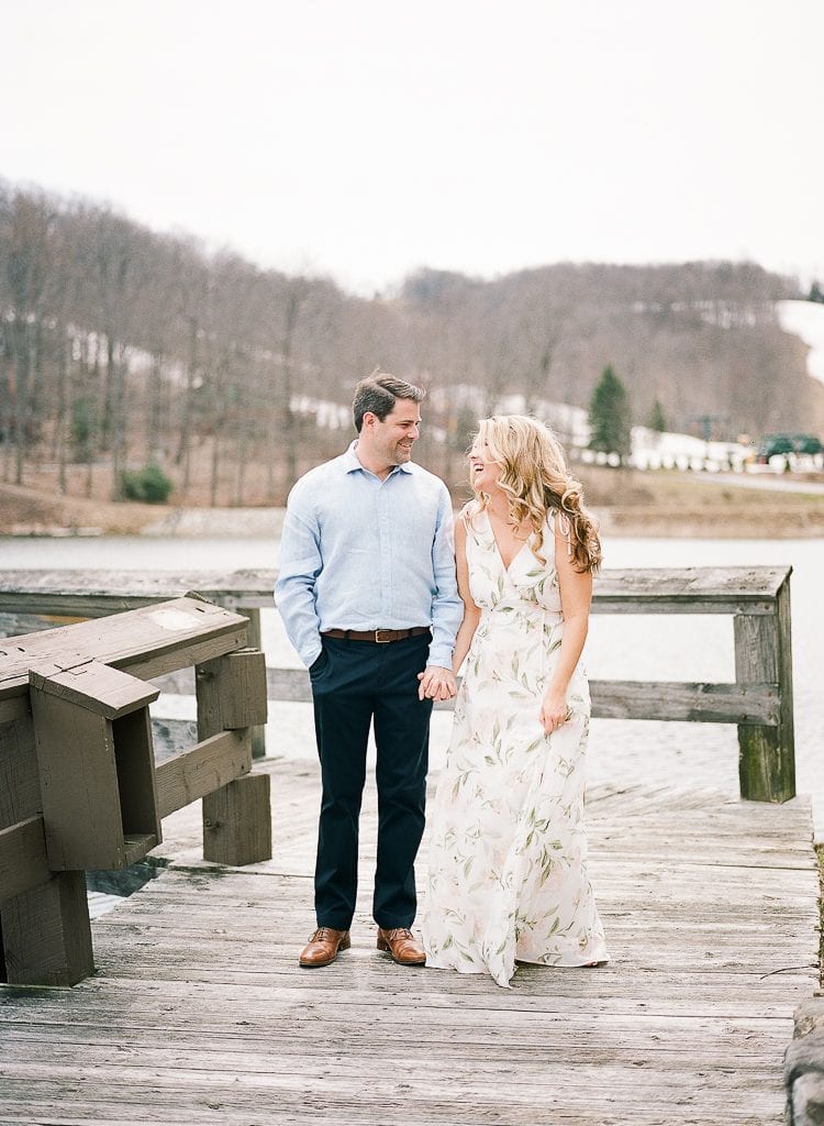 Seven Springs Engagement Photography - Bride and Groom holding hands on a dock